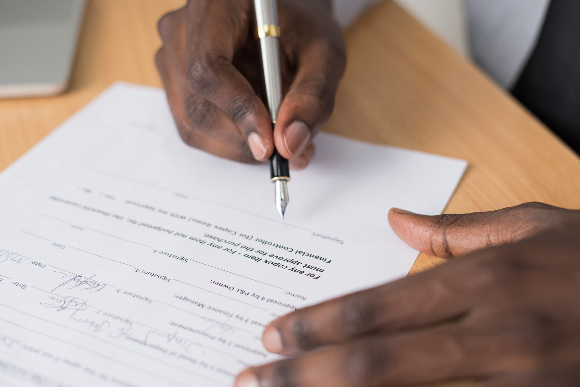 A fountain pen resting on a printed agreement