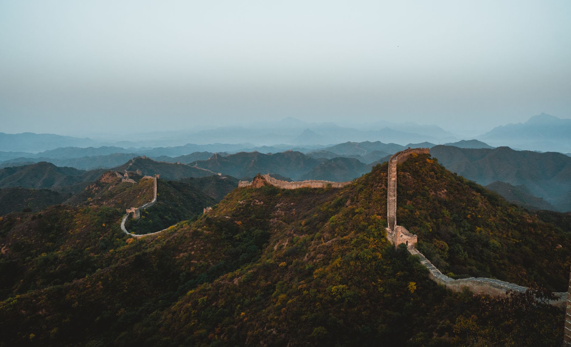 The Great Wall of China crossing forested ridges